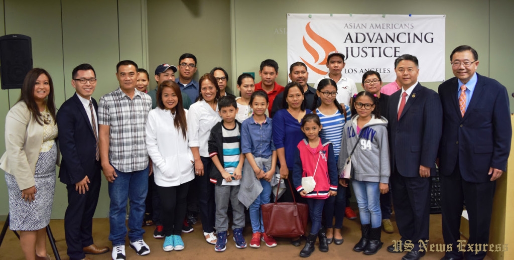 Trafficking victims from the Philippines and their family members pose with Congressmember Ted Lieu and staff members from Asian Americans Advancing Justice-Los Angeles, who helped the workers attain T visas. 