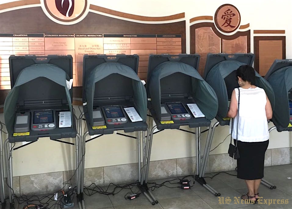A voter casts her ballot at Irvine Chinese Cultural Center. Photo by Keyang Pang